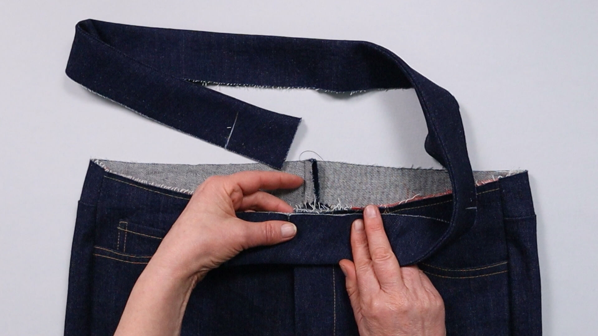 smartPATTERN sewing instructions for preparing a pair of jeans - for fitting - pin the waistband to the left front piece