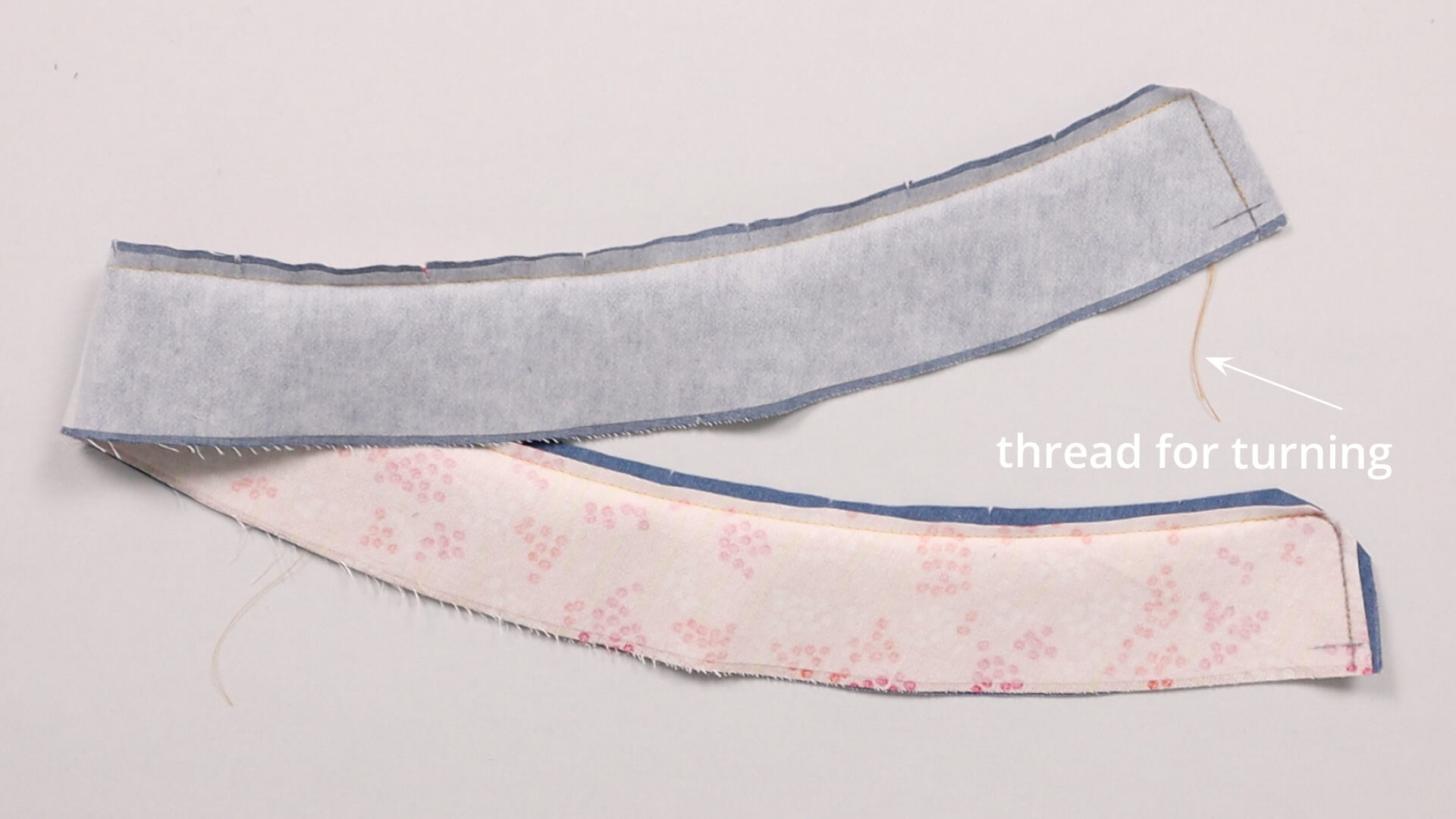 The picture shows a waistband strip with differently finished corners.