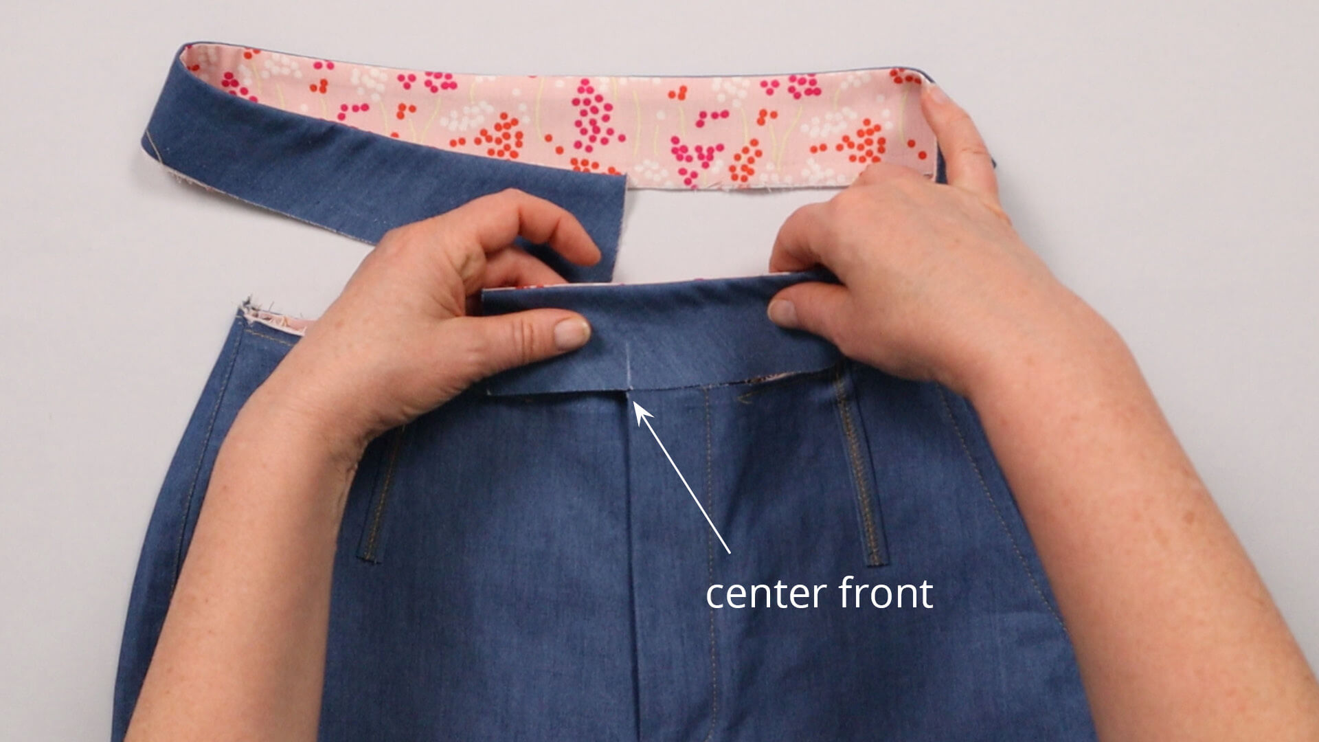 The picture shows how the left side of the waistband is placed at the center front.