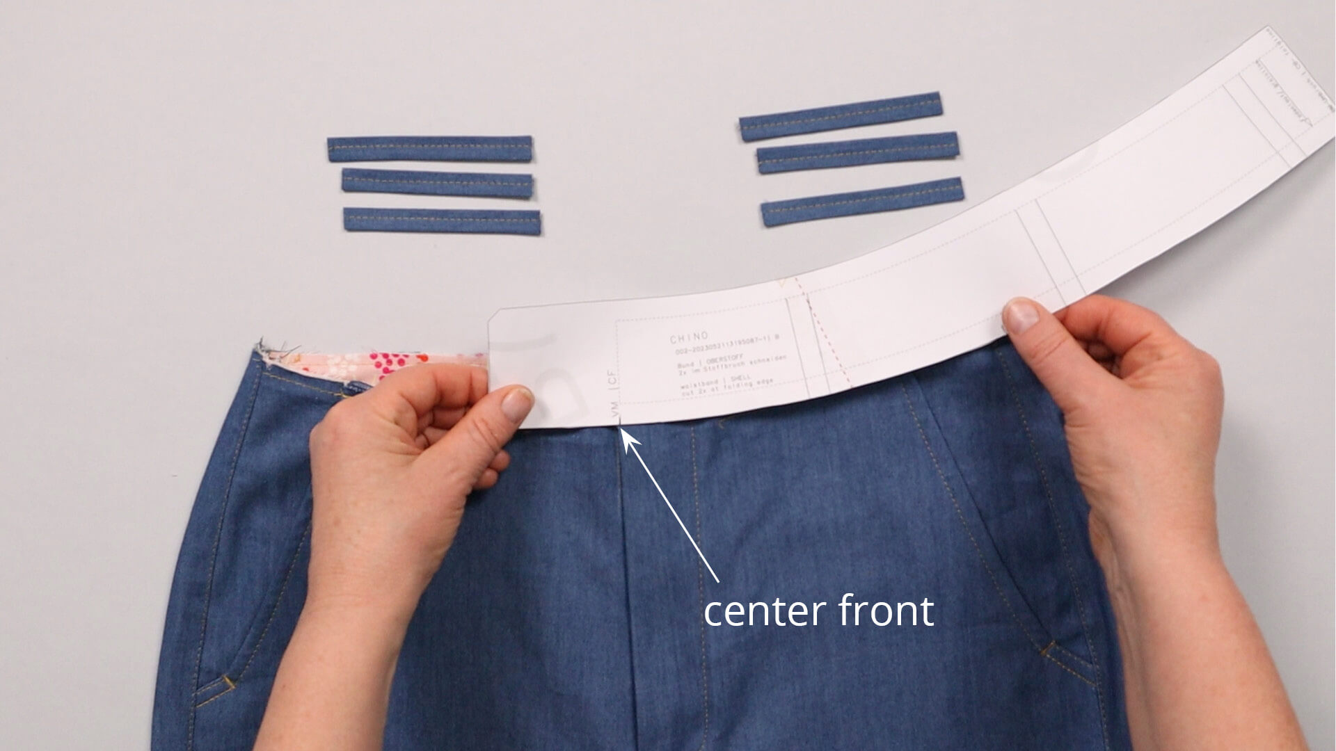 The picture shows how to mark the position of the belt loops on the front trousers.