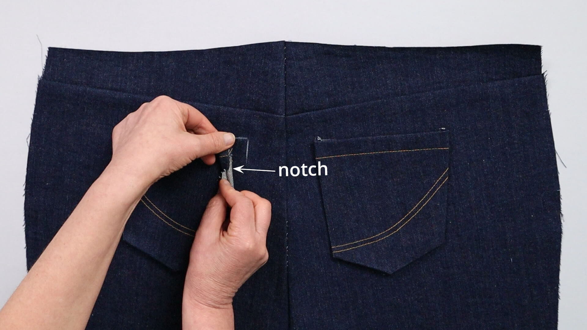 smartPATTERN sewing instructions for preparing a pair of jeans - for fitting - place right pocket with snap to seat seam on back trousers