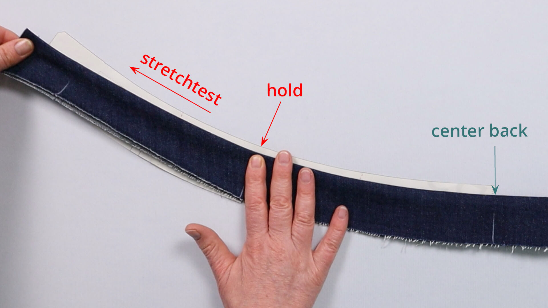 Stretch test in the front area of the shaped waistband after sewing the upper edge of the waistband