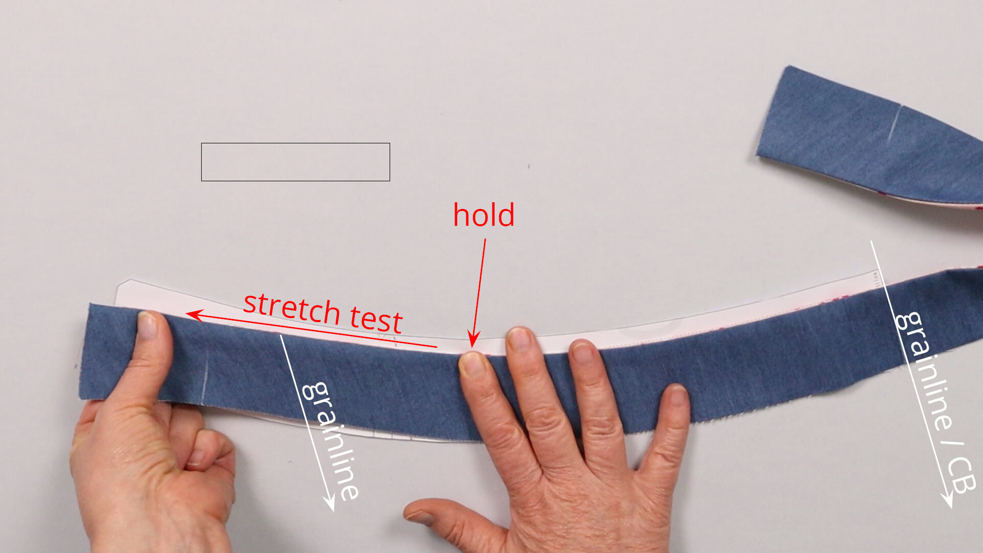 Hold the shaped waistband at the height of the side seam at the shortened upper edge of the waistband and test whether the seam at the front where the thread is diagonal still stretches